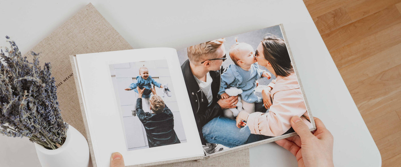 Baby photo book with images of parents and baby.