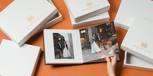 A lay flat photograph of a wedding photo album and Bonmatch Christmas boxes.