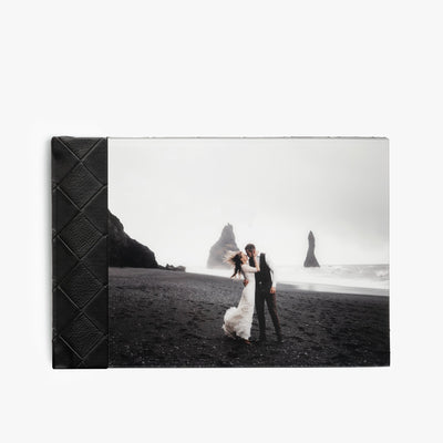 Black checkered leather photo album with a picture of a woman kissing a man.